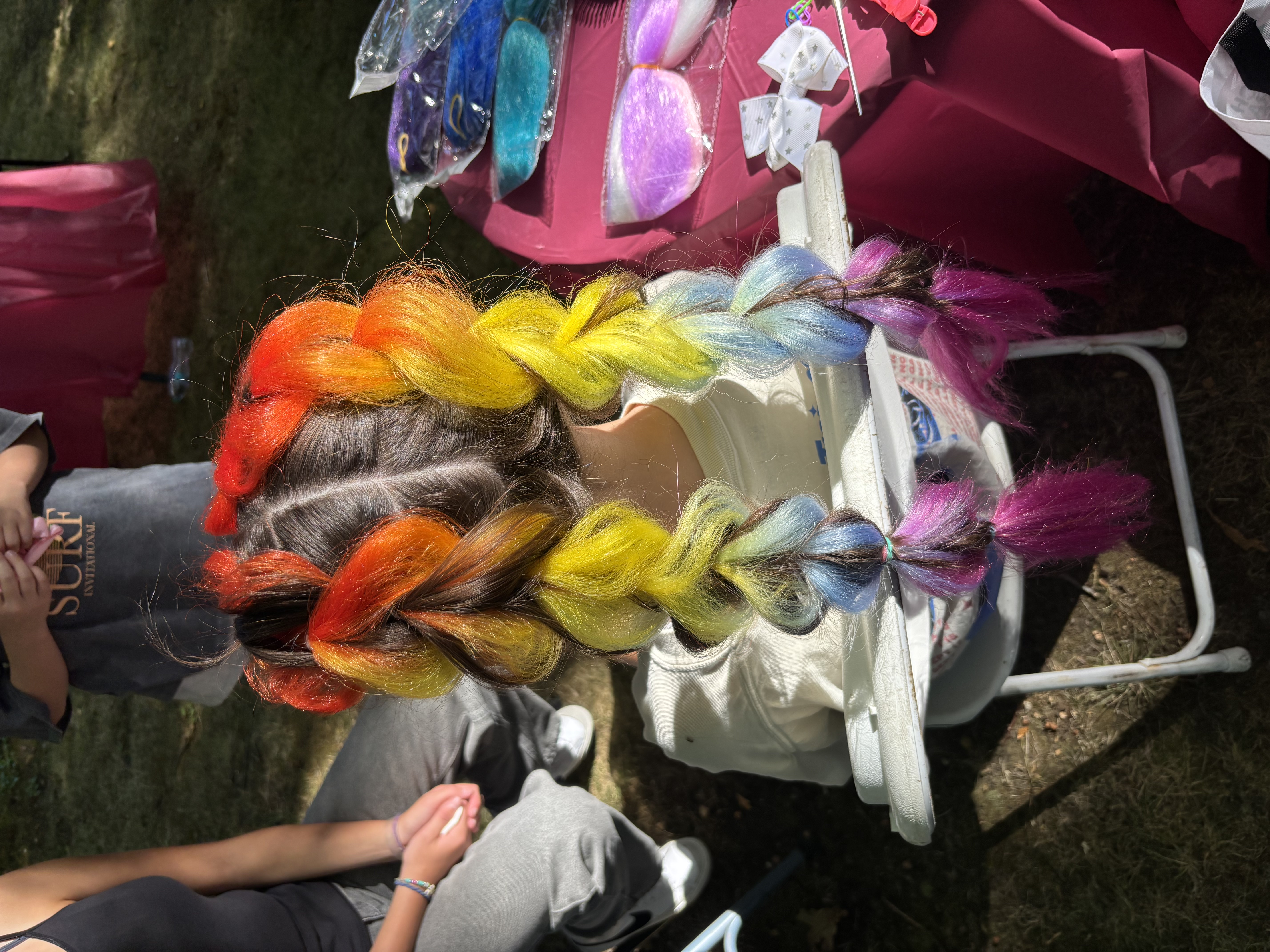Birthday party hairstyle with colorful buns and sparkle